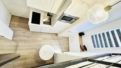 an open living room with a kitchen in a house at Croisette Studio 1 min beach in Cannes