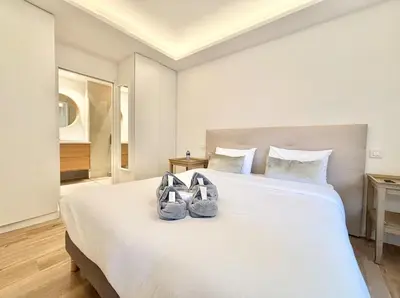 a bedroom with a large white bed with two shoes on it at Cannes 2x2 bedrooms apartment - 24P3 in Cannes