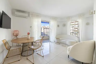a living room with a table and chairs at Splendid apartment a-c 2BR-4P - Sea View in Cannes