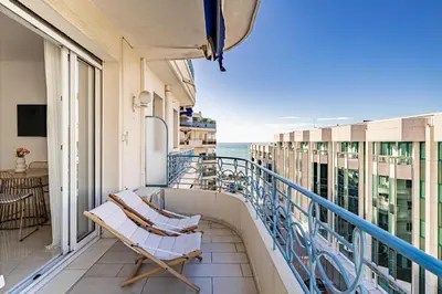 a balcony with two chairs and a view of the ocean at Splendid apartment a-c 2BR-4P - Sea View in Cannes