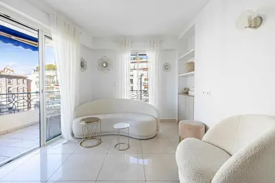 a living room with white furniture and a balcony at Splendid apartment a-c 2BR-4P - Sea View in Cannes