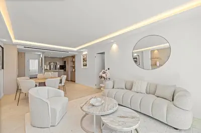 a living room with a couch and a table at REF 2042 - Cannes Croisette - Apartment for rent in Cannes