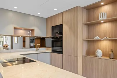 a kitchen with wooden cabinets and a counter top at REF 2042 - Cannes Croisette - Apartment for rent in Cannes