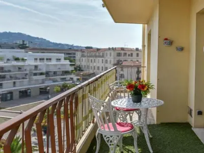 a table and chairs on a balcony with a view at Apartment Boite d'Amour Wohnung mit Terrasse und Solarium by Interhome in Cannes