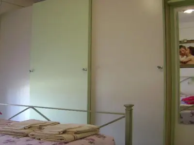 a bedroom with a bed and a mirror at Apartment Boite d'Amour Wohnung mit Terrasse und Solarium by Interhome in Cannes