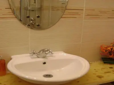 a white sink in a bathroom with a mirror at Apartment Boite d'Amour Wohnung mit Terrasse und Solarium by Interhome in Cannes