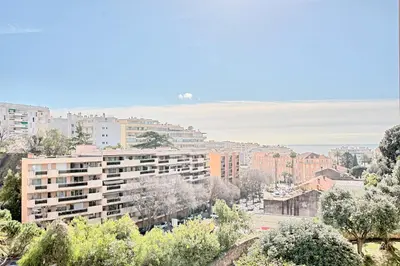a view of a city with buildings and trees at Appartement Vallombrosa proche Plages et Palais in Cannes