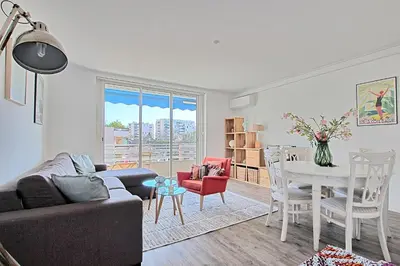 a living room with a couch and a table at Appartement Vallombrosa proche Plages et Palais in Cannes