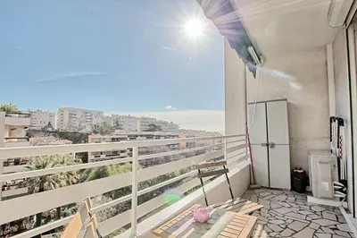 a balcony with chairs and a view of the ocean at Appartement Vallombrosa proche Plages et Palais in Cannes