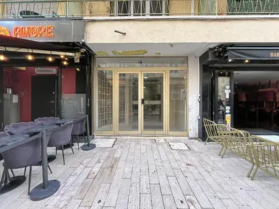 a patio with tables and chairs in front of a store at 2 bedroom Pradignac 305 in Cannes