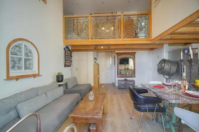 a living room with a couch and a table at 6Bedroom Duplex with Sauna, AC Wi-Fi Central Cannes in Cannes