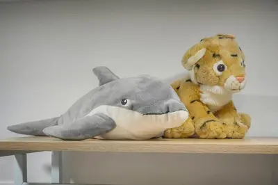 a stuffed dolphin and a stuffed rabbit sitting on a shelf at 6Bedroom Duplex with Sauna, AC Wi-Fi Central Cannes in Cannes