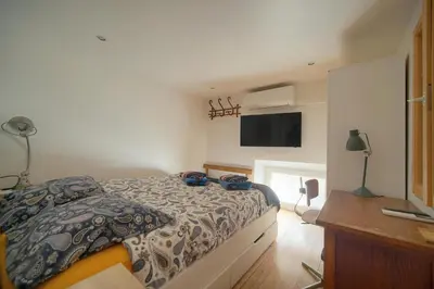 a bedroom with a bed and a flat screen tv at 6Bedroom Duplex with Sauna, AC Wi-Fi Central Cannes in Cannes