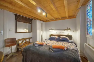 a bedroom with a bed with two people laying on it at 6Bedroom Duplex with Sauna, AC Wi-Fi Central Cannes in Cannes