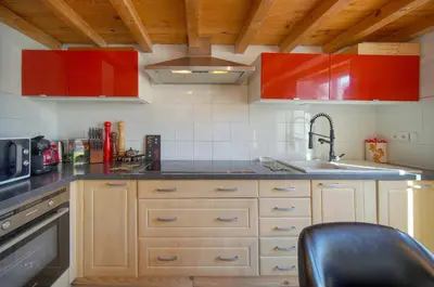 a kitchen with red cabinets and a sink at 6Bedroom Duplex with Sauna, AC Wi-Fi Central Cannes in Cannes