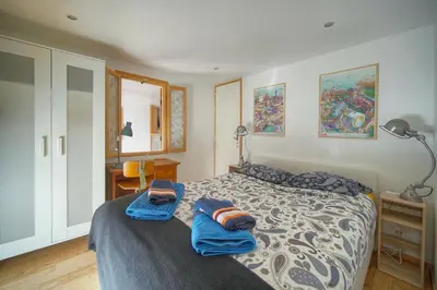 a bedroom with a bed with two blue towels on it at 6Bedroom Duplex with Sauna, AC Wi-Fi Central Cannes in Cannes