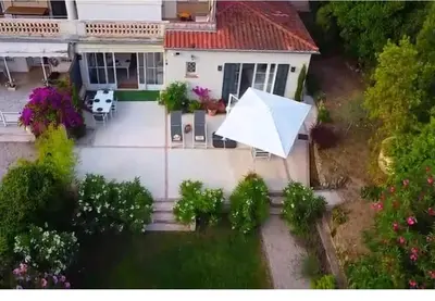 an aerial view of a house with a large white umbrella at Elegant 3-BR Cannes Garden Condo - 5 Min Walk to Beach - behind Martinez in Cannes