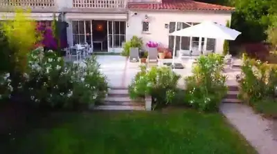 a house with a garden in front of it at Elegant 3-BR Cannes Garden Condo - 5 Min Walk to Beach - behind Martinez in Cannes