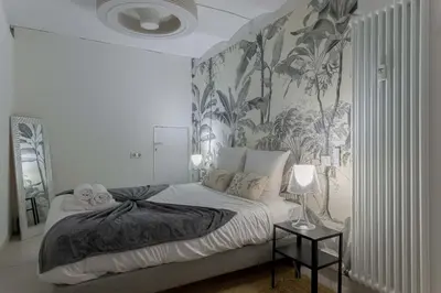 a bedroom with a large bed with a wall mural at Louison balcony, quiet area, 7mn from beach in Cannes