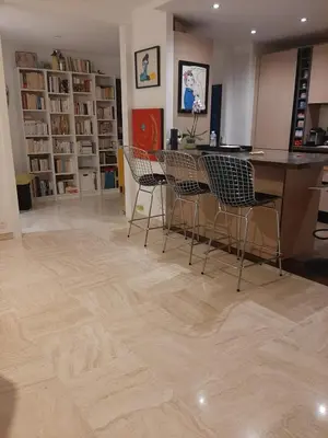 a room with a wooden floor with chairs and a table at Appartement Ima in Cannes