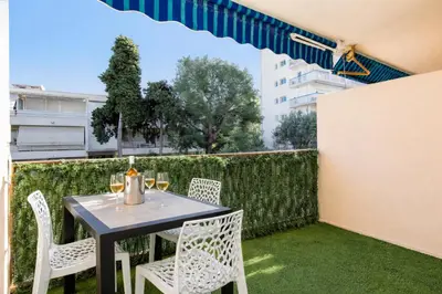 a table and chairs on the balcony of a building at Le Palm - Croisette - Beach - Casino - Wi-Fi in Cannes