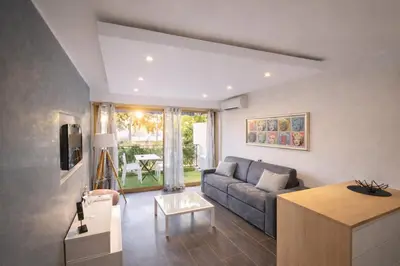 a living room with a couch and a table at Le Palm - Croisette - Beach - Casino - Wi-Fi in Cannes