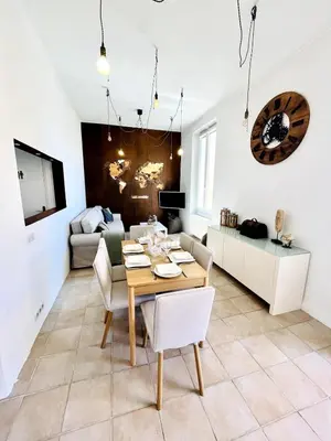 a living room with a table and a couch at Appartement Calme Proche Plages in Cannes