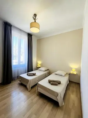 a room with two beds and a window at Appartement Calme Proche Plages in Cannes