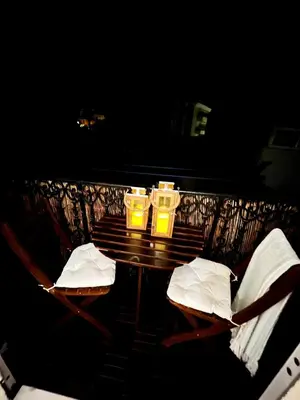 two candles sitting on a table with two chairs at Appartement Calme Proche Plages in Cannes