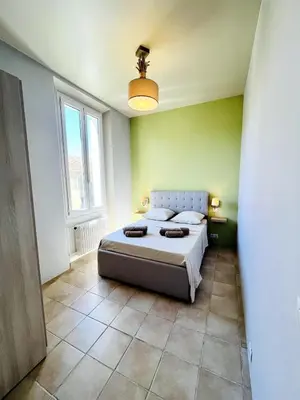 a bedroom with a large bed in a room at Appartement Calme Proche Plages in Cannes