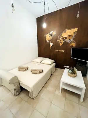a bedroom with two beds and a painting on the wall at Appartement Calme Proche Plages in Cannes
