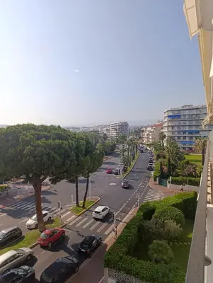 a city street with cars parked in a parking lot at Viva Riviera Studio Croisette Terrace Sea View in Cannes