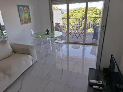 a living room with a glass table and a couch at Viva Riviera Studio Croisette Terrace Sea View in Cannes