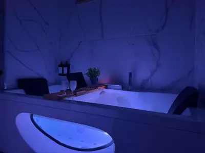 a bathroom with a tub with a toilet in it at Studio Évasion Balneo, Clim, Wifi, Netflix, Palais in Cannes