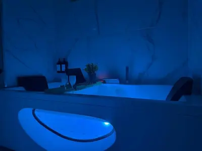 a bathroom with a toilet in a blue room at Studio Évasion Balneo, Clim, Wifi, Netflix, Palais in Cannes