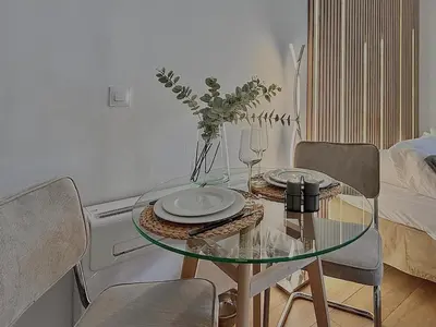 a dining room table with chairs and a glass table at Studio Évasion Balneo, Clim, Wifi, Netflix, Palais in Cannes
