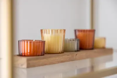 a row of different colored cups on a shelf at LB Vacation Rentals I Fully Renovated Apt Min from Palais - Beach in Cannes