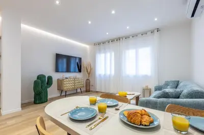 a living room with a table with a plate of food at LB Vacation Rentals I Fully Renovated Apt Min from Palais - Beach in Cannes