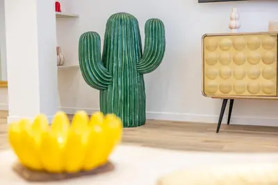 a cactus and a yellow rubber duck in a living room at LB Vacation Rentals I Fully Renovated Apt Min from Palais - Beach in Cannes