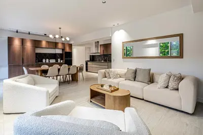 a living room with two couches and a dining room at Luxury apt 5 min from the beach and La Croisette in Cannes