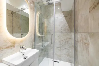 a bathroom with a sink and a glass shower at Luxury apt 5 min from the beach and La Croisette in Cannes