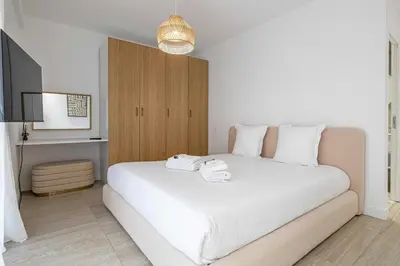a bedroom with a large white bed in a room at Luxury apt 5 min from the beach and La Croisette in Cannes