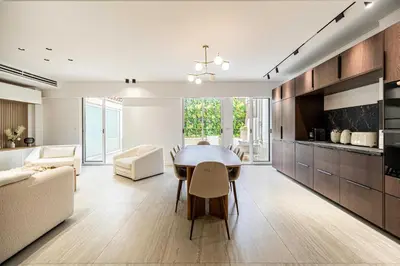 a kitchen and dining room with a table and chairs at Luxury apt 5 min from the beach and La Croisette in Cannes