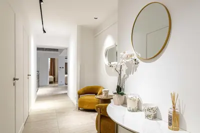 a living room with a mirror on the wall at Luxury apt 5 min from the beach and La Croisette in Cannes