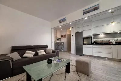 a bedroom with a large bed and a window at Appartement une chambre - Cannes Suquet in Cannes