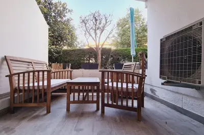 a patio with two chairs and a table and a window at Charming studio with terrace in Cannes