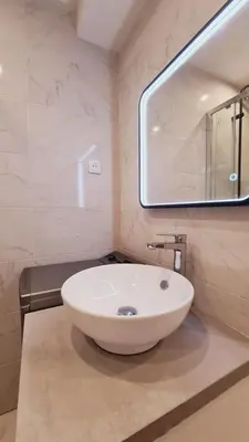 a bathroom with a white sink and a mirror at Charming studio with terrace in Cannes