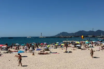 a large group of people on a beach at Charming studio with terrace in Cannes