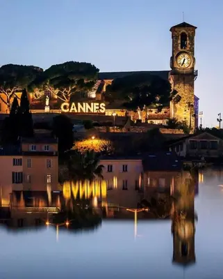 a clock tower and buildings with a clock tower at Appartement moderne et chaleureux à 2 minutes du Palais in Cannes