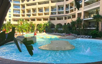 a swimming pool in front of a large building at Apartmens 1-st line Cannes Beach in Cannes